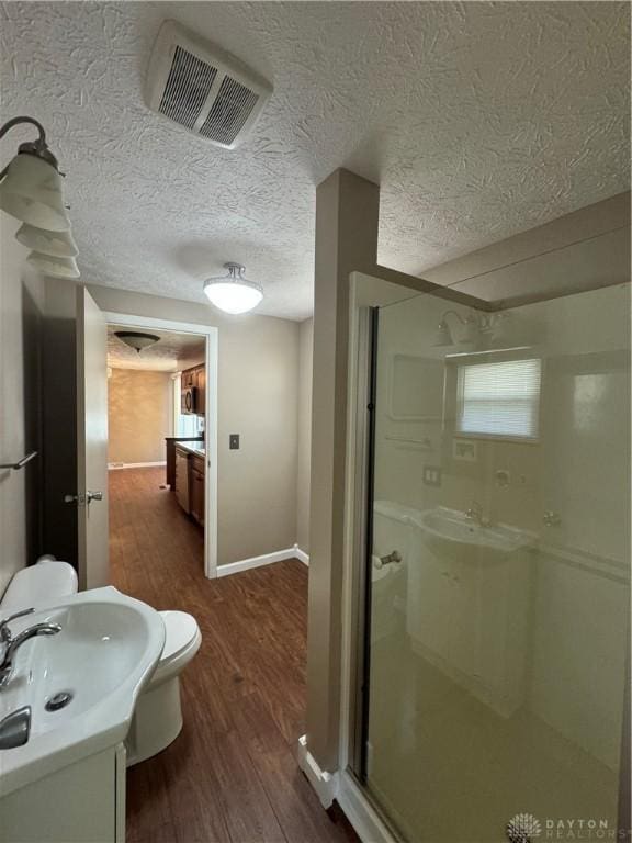 4130 Chalfant Dr, Medway, OH 45341 - bathroom with visible vents, baseboards, a sink, wood finished floors, and a stall shower