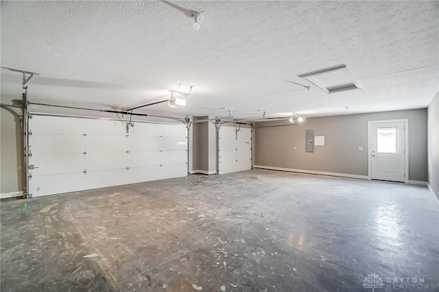 garage featuring electric panel and a garage door opener