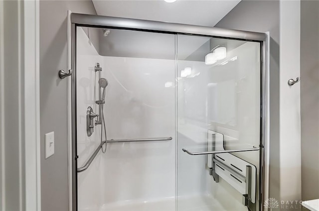 bathroom with a shower with door