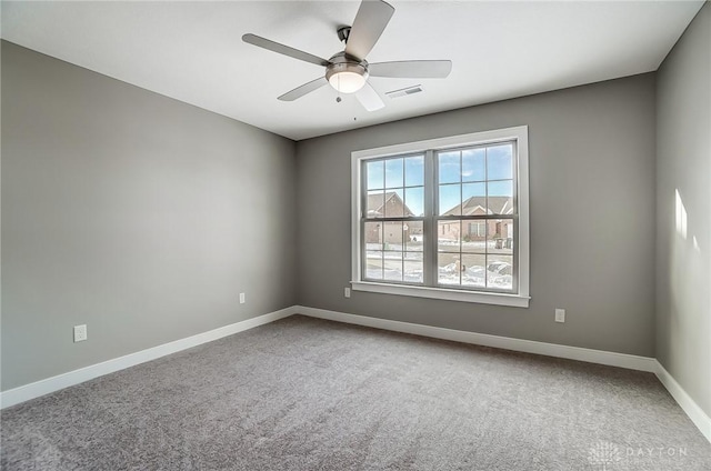 empty room featuring ceiling fan and carpet floors