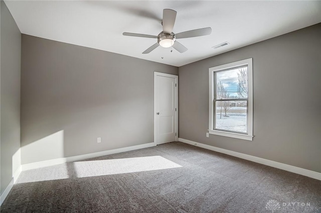 spare room featuring carpet and ceiling fan