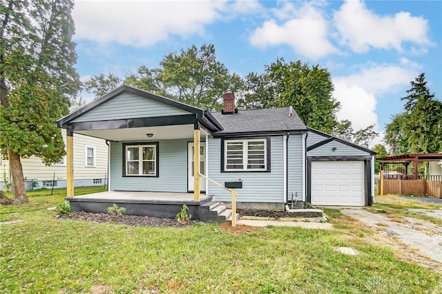 bungalow with driveway, a garage, a chimney, a porch, and a front lawn