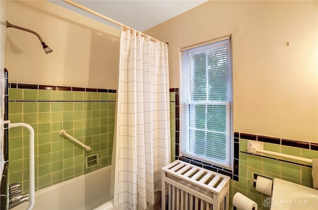 bathroom with shower / tub combo and tile walls