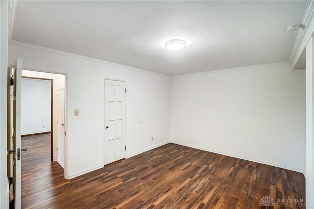 unfurnished bedroom featuring crown molding and dark hardwood / wood-style flooring