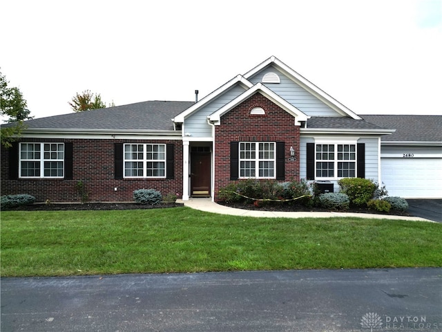 ranch-style home featuring a garage and a front yard