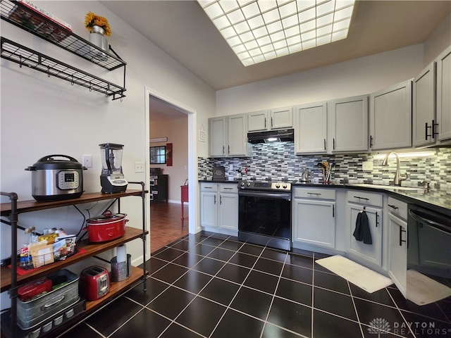 kitchen featuring electric stove, black dishwasher, dark tile patterned flooring, and sink