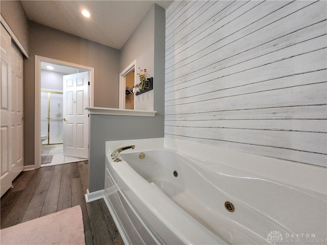 bathroom featuring independent shower and bath and hardwood / wood-style floors