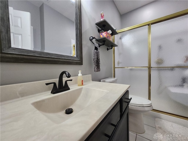 bathroom featuring vanity, a shower with shower door, toilet, and tile patterned floors