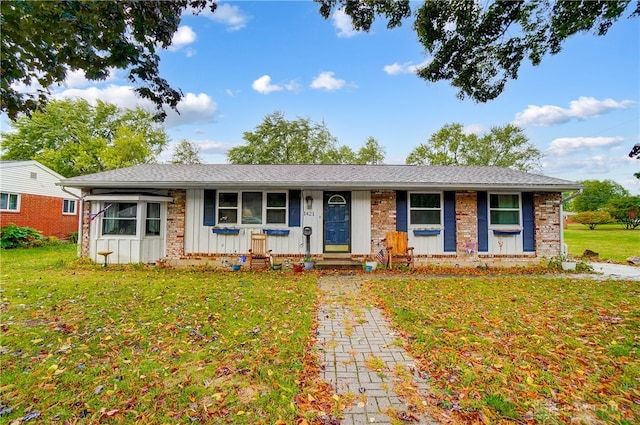 single story home featuring covered porch and a front yard