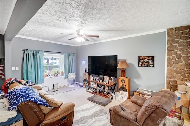 living room with ornamental molding, ceiling fan, carpet flooring, and a textured ceiling