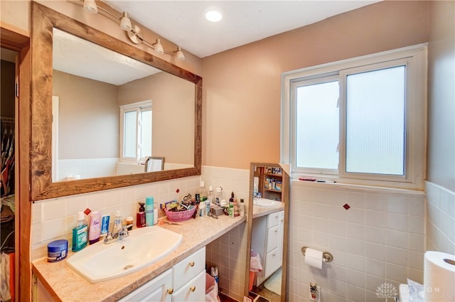 bathroom with tile walls and vanity