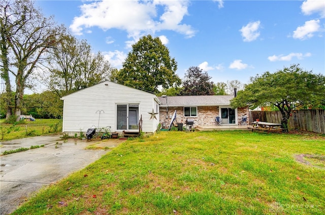 rear view of house with a yard