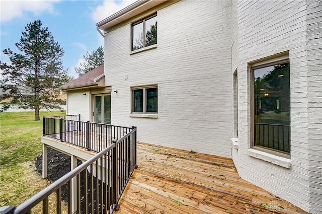 wooden deck featuring a yard