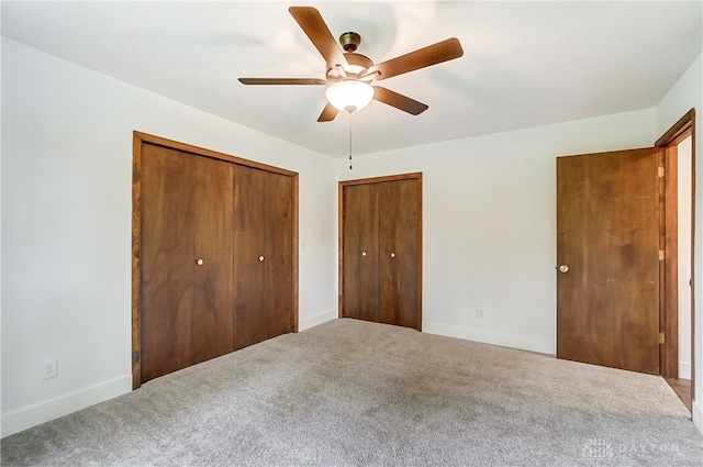 unfurnished bedroom with ceiling fan and carpet floors