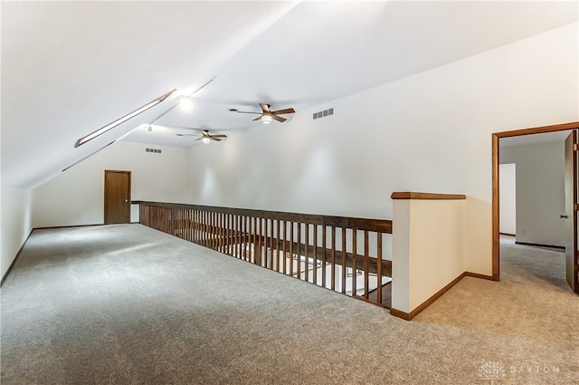 additional living space featuring ceiling fan, light colored carpet, and lofted ceiling