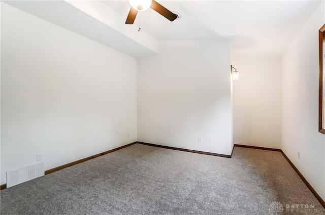 unfurnished room with ceiling fan and carpet