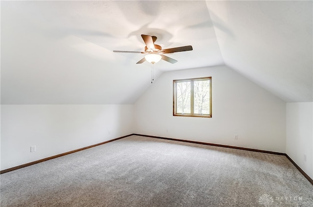 additional living space with carpet floors, lofted ceiling, and ceiling fan