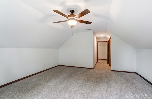 bonus room with light carpet, vaulted ceiling, and ceiling fan