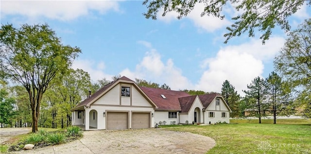 tudor-style house featuring a front lawn and a garage