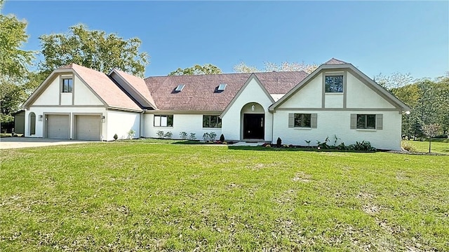 tudor-style house with a front lawn and a garage