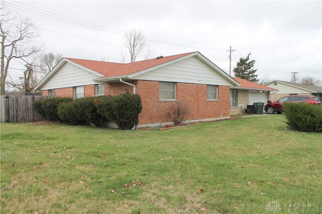 view of side of home featuring a yard