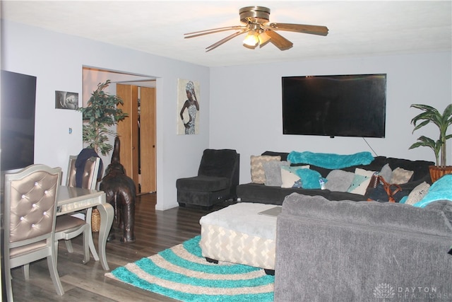 living room with ceiling fan and dark hardwood / wood-style flooring