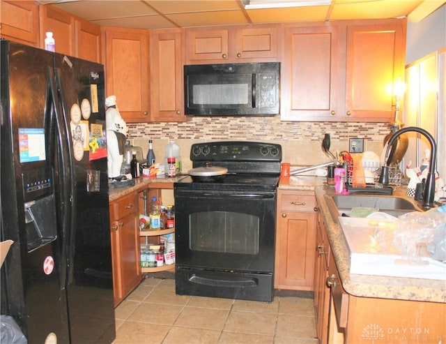 kitchen with black appliances, decorative backsplash, sink, and light tile patterned floors