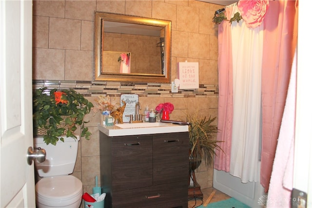 bathroom featuring tile walls, vanity, and toilet