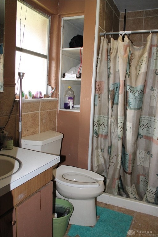 bathroom featuring vanity, toilet, and a shower with curtain