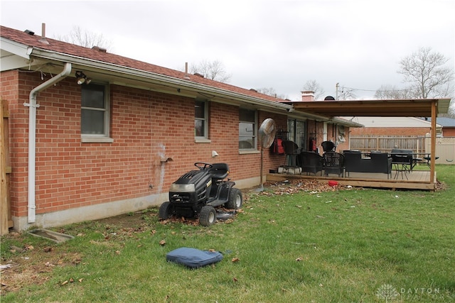 back of property featuring a yard and a wooden deck