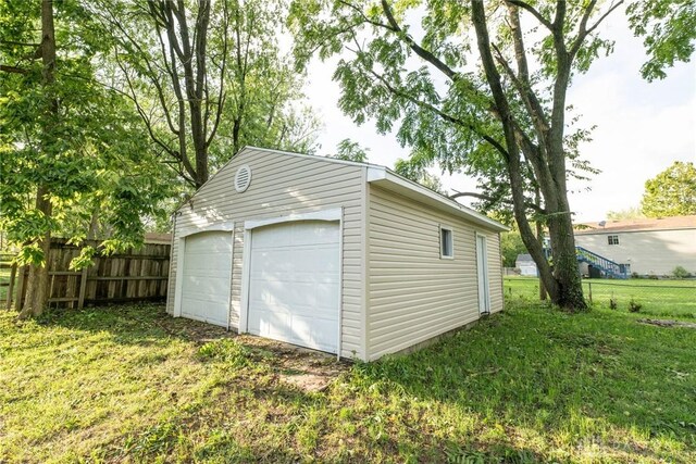 garage featuring a lawn