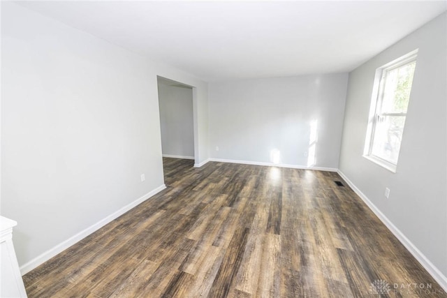 empty room with dark hardwood / wood-style floors