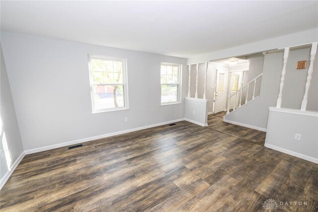 unfurnished room with dark hardwood / wood-style flooring