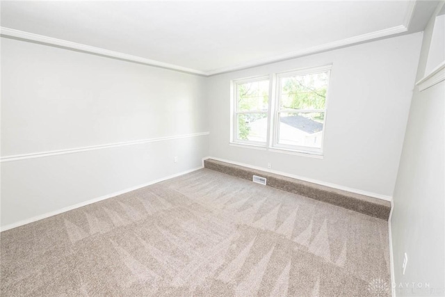 carpeted spare room with ornamental molding