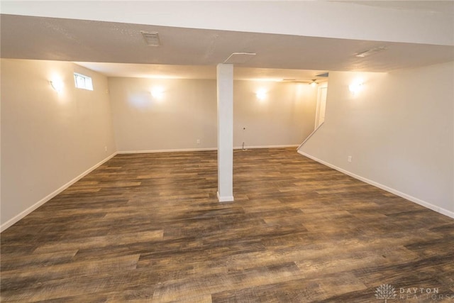 basement with dark hardwood / wood-style floors