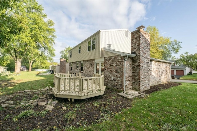 rear view of house with a lawn and a deck