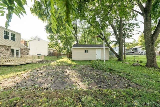 view of yard with a deck and an outbuilding