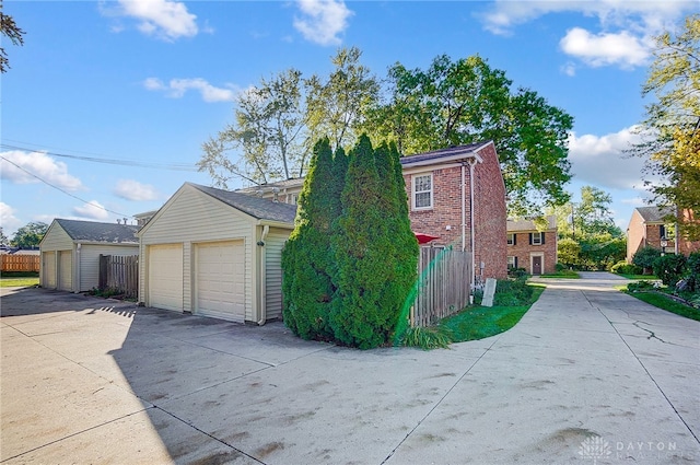 view of property exterior featuring an outdoor structure and a garage