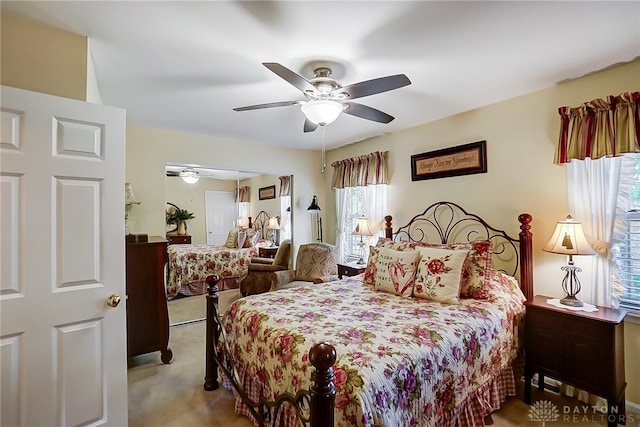 bedroom with a closet, ceiling fan, and light colored carpet