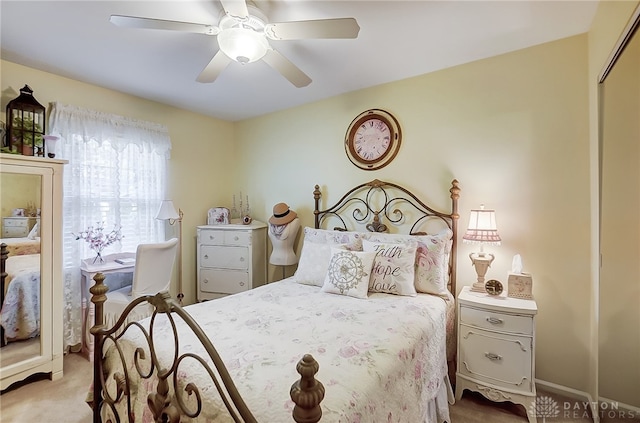 bedroom with ceiling fan, light colored carpet, and a closet