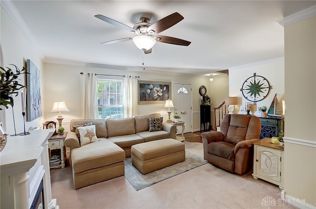 living room featuring ceiling fan, light colored carpet, and crown molding