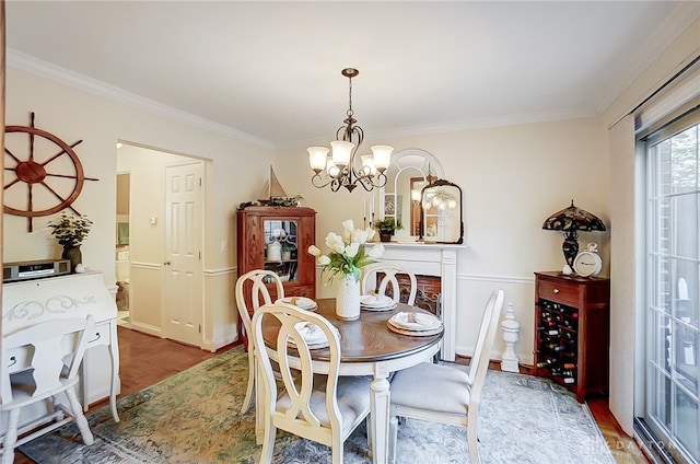 dining area featuring a notable chandelier, hardwood / wood-style floors, and ornamental molding