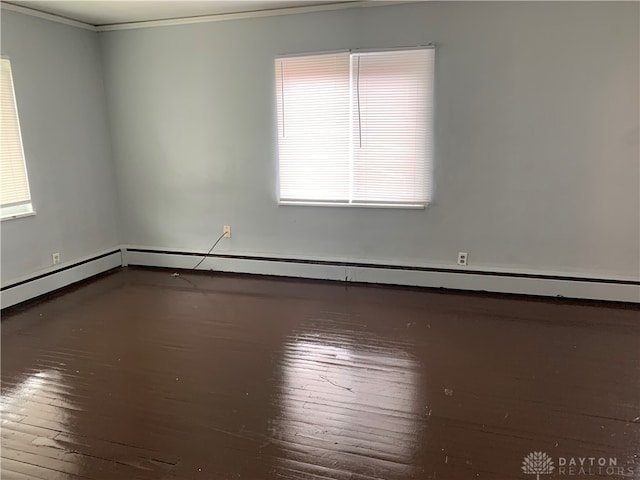 empty room featuring crown molding, a wealth of natural light, and hardwood / wood-style flooring