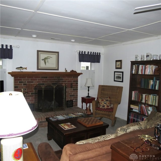 carpeted living room with a fireplace and crown molding