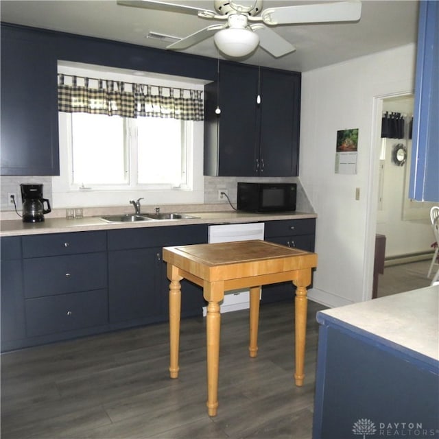 kitchen featuring tasteful backsplash, dark wood-type flooring, and sink