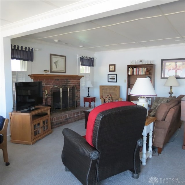 living room with ornamental molding, a brick fireplace, carpet floors, and a healthy amount of sunlight