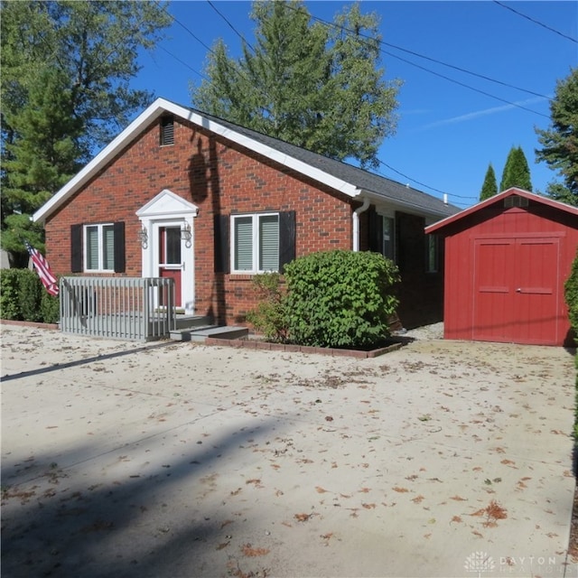 ranch-style house featuring a storage shed