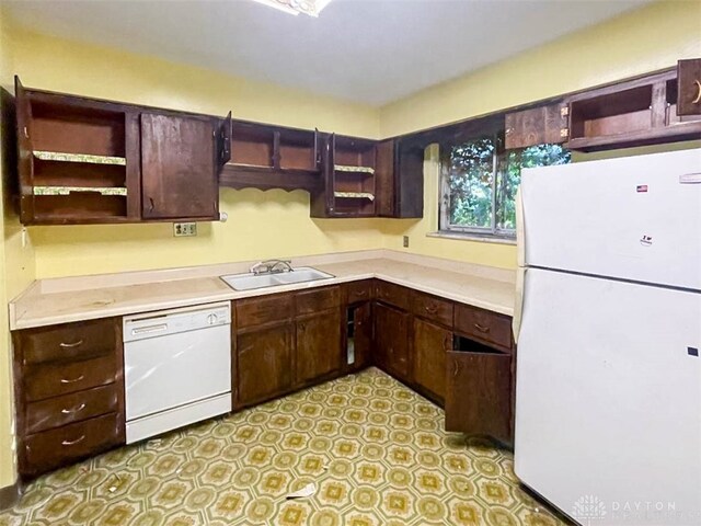 kitchen featuring dark brown cabinets, white appliances, and sink