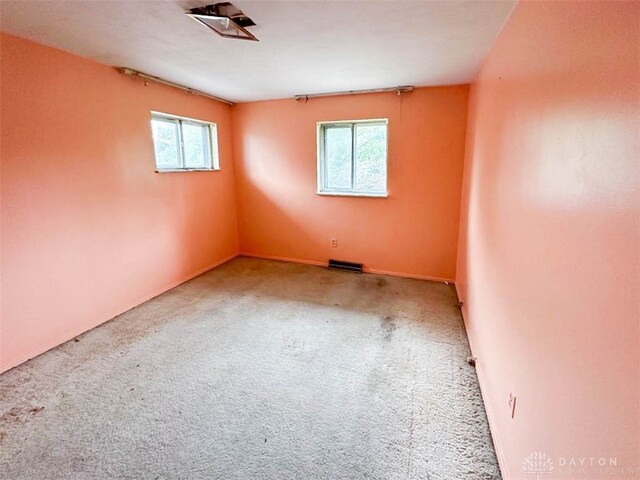 carpeted empty room featuring a wealth of natural light