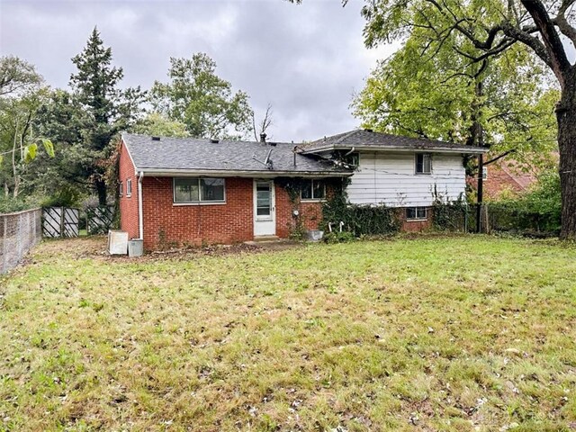 back of property featuring a lawn